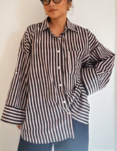 Load image into Gallery viewer, Model wearing the Signature Big Shirt in black stripe, hand block-printed cotton, with sleeves buttoned