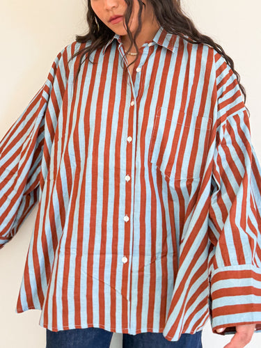 Front view of model wearing the Signature Big Shirt in blue and brown stripe, hand block-printed cotton button up.