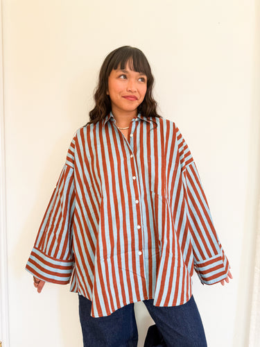Front view of model wearing the Signature Big Shirt in blue and brown stripe, showing oversized fit and hand block-printed cotton