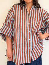 Load image into Gallery viewer, Model wearing the Signature Big Shirt in blue and brown stripe, showing oversized fit and sleeves buttoned