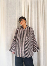 Load image into Gallery viewer, Front view of model wearing the Signature Big Shirt in black stripe, hand block-printed cotton, with oversized sleeves down