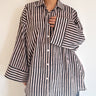 Front view of model wearing the Signature Big Shirt in black stripe, showing oversized sleeves and block-printed cotton
