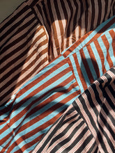 Load image into Gallery viewer, Closeup of the Signature Big Shirt in black stripe, brown stripe, and blue and brown stripe, showing the hand block-printed cotton shirts
