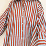 Front view of model wearing the Signature Big Shirt in blue and brown stripe, hand block-printed cotton button up.