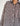 Closeup of model wearing the Signature Big Shirt in black stripe, showing button down block-printed cotton and buttons on oversized sleeves
